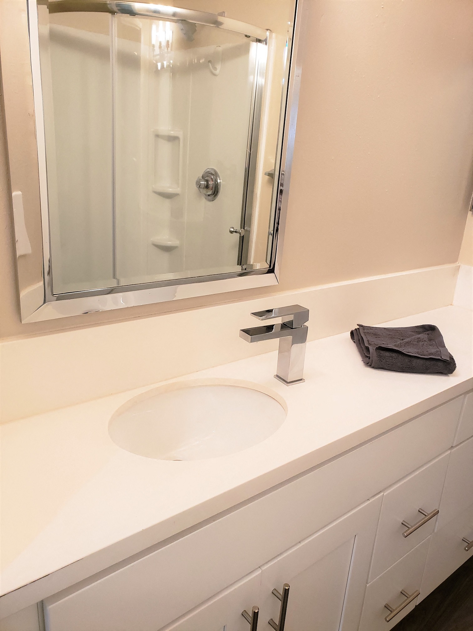 Master Bathroom with a modern round standing shower in the Ebony a 2BR 2BA